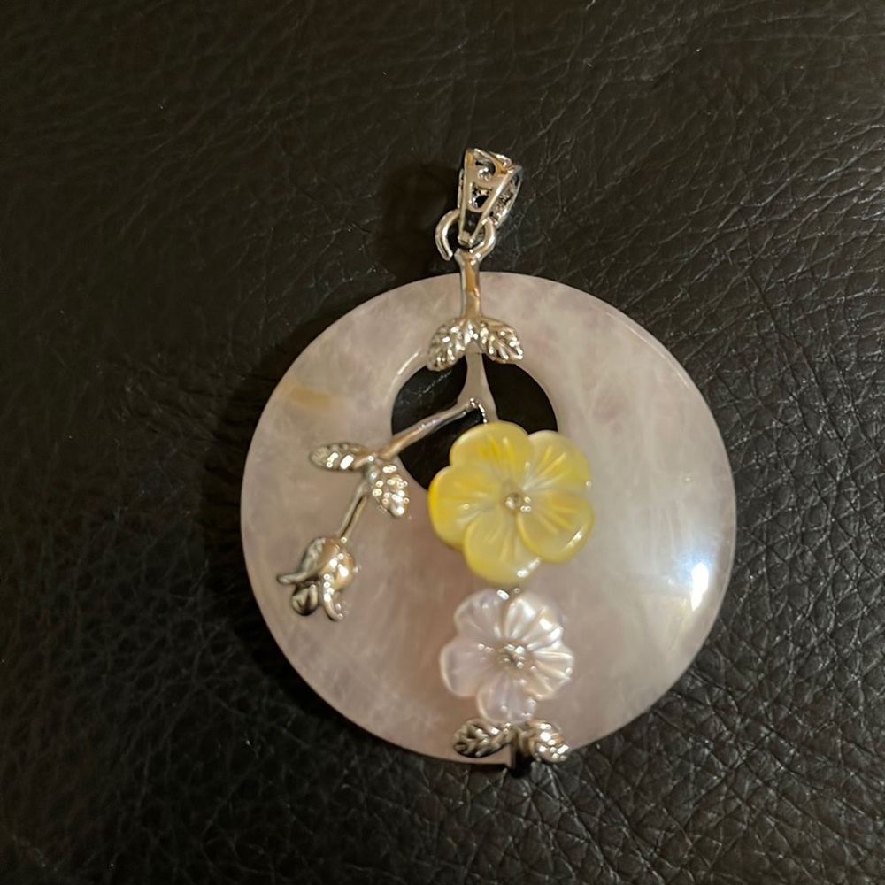 A Beautiful natural rose quartz flowers carved shell gemstone pendant.